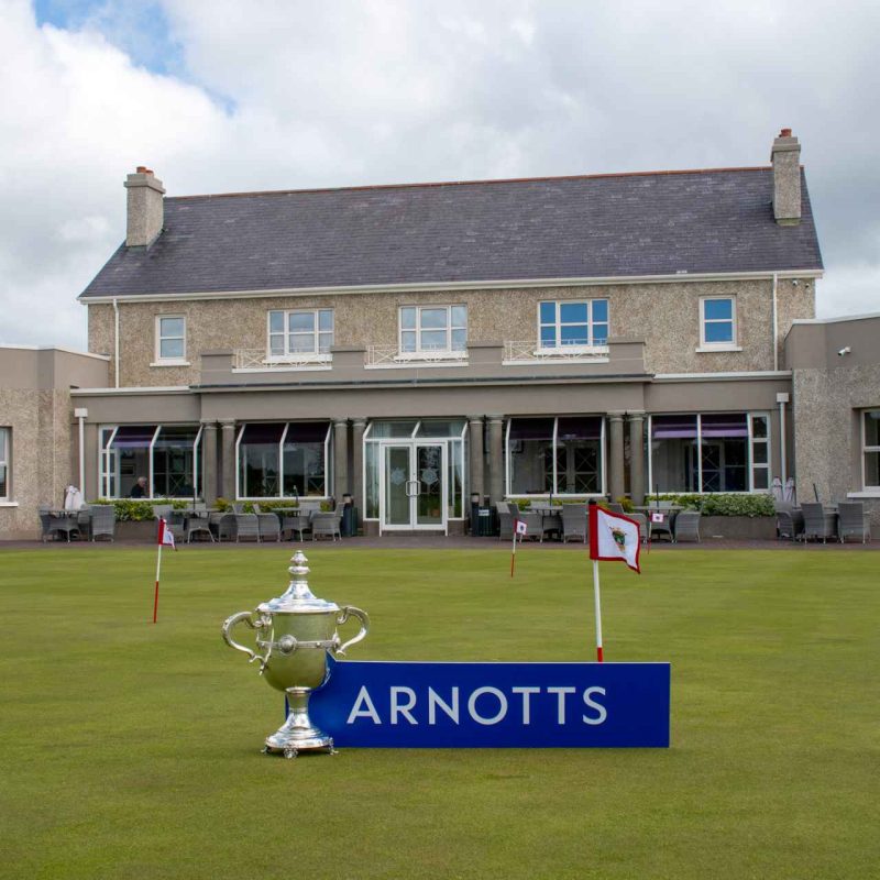 County Louth Golf Club clubhouse with East of Ireland Championship trophy and Arnotts plaque beside it