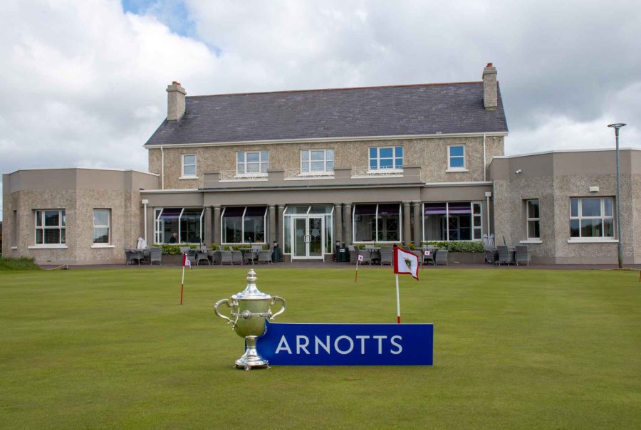 County Louth Golf Club clubhouse with East of Ireland Championship trophy and Arnotts plaque beside it